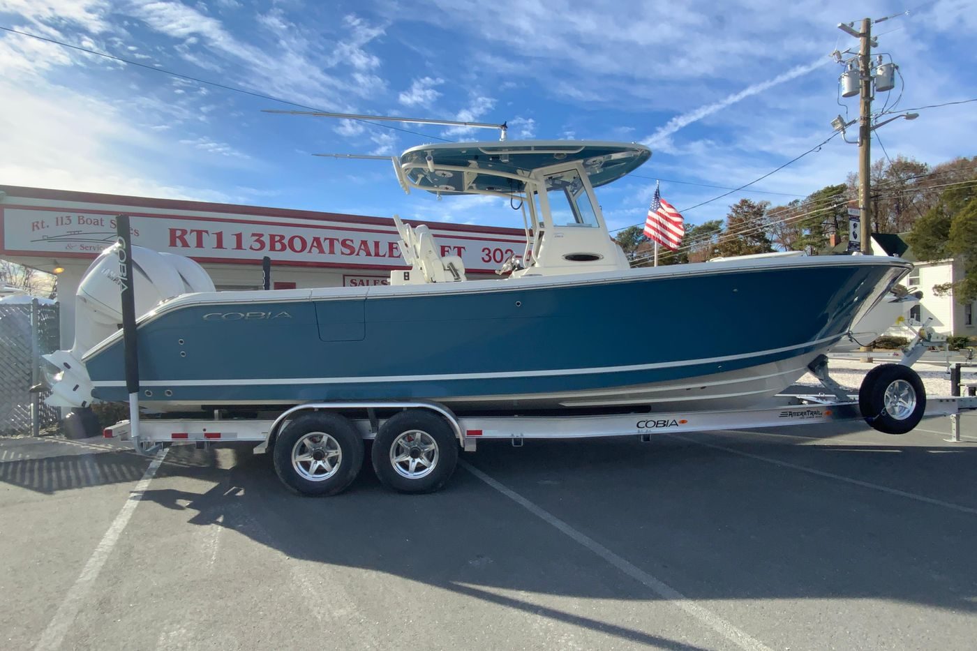 2026 Cobia 285 Center Console boat on trailer at dealership.