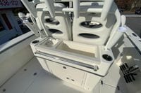 2026 Cobia 285 Center Console boat interior with rod holders and storage.