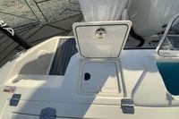 2026 Cobia 285 Center Console boat deck with open storage compartment.