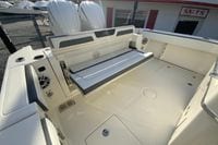 2026 Cobia 285 Center Console boat interior with foldable seating and twin engines.