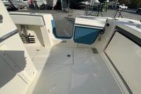 2026 Cobia 285 Center Console boat interior with blue accents and storage compartments.