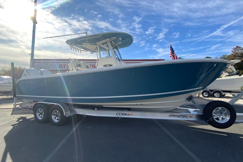 2026 Cobia 285 Center Console boat on trailer under clear sky.