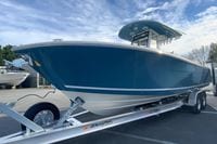 2026 Cobia 285 Center Console boat on trailer under blue sky.