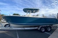2026 Cobia 285 Center Console boat on trailer, parked outdoors under a blue sky.