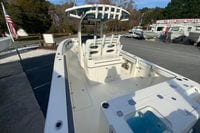 2026 Cobia 285 Center Console boat at dealership, showcasing spacious deck and seating.