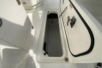 2026 Pursuit DC 266 Dual Console boat storage compartment open, showcasing interior space.