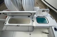 2026 Pursuit DC 266 Dual Console boat with open storage compartments and seating.