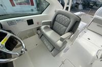 2026 Pursuit DC 266 Dual Console boat interior with luxurious seating and steering wheel.