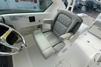2026 Pursuit DC 266 Dual Console boat interior with luxurious captain's seat and steering wheel.