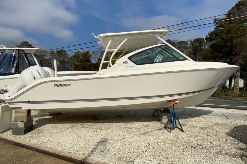 2026 Pursuit DC 266 Dual Console boat on display, featuring sleek design and Yamaha engine.