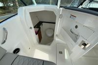 2026 Pursuit DC 266 Dual Console boat interior with compact bathroom and sink.