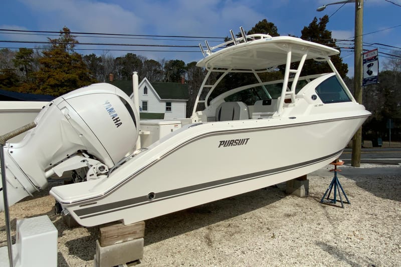 2026 Pursuit DC 266 Dual Console boat with Yamaha engine on display outdoors.