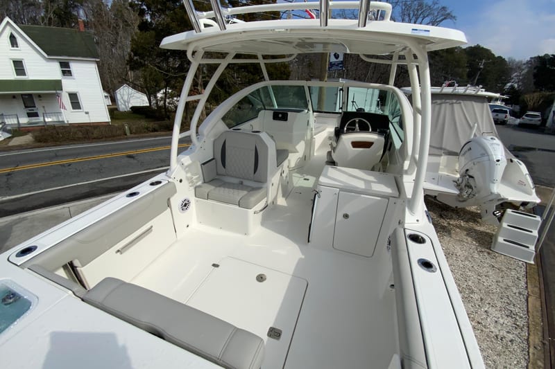2026 Pursuit DC 266 Dual Console boat interior with seating and steering wheel.