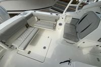 2026 Pursuit DC 266 Dual Console boat interior with gray seating and storage compartments.