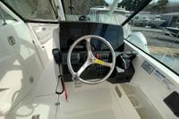 2026 Pursuit DC 266 Dual Console boat cockpit with steering wheel and control panel.