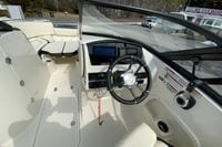 2023 Stingray 231 DC boat interior with steering wheel and dashboard controls.