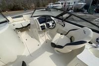 2023 Stingray 231 DC boat interior with steering wheel and seating area.