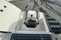 2023 Stingray 231 DC boat with open hatch and ladder on deck.