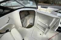 2023 Stingray 231 DC boat interior with open cabin door and seating area.