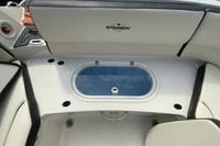 2023 Stingray 231 DC boat interior with seating and storage compartment.