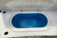 Livewell compartment on 2023 Stingray 231 DC boat, featuring a blue interior.