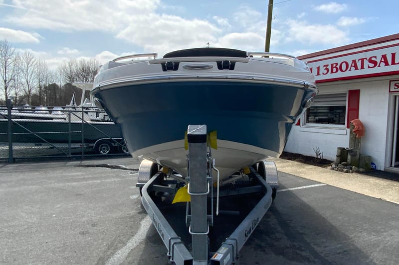 2023 Stingray 231 DC boat on trailer at dealership, front view.