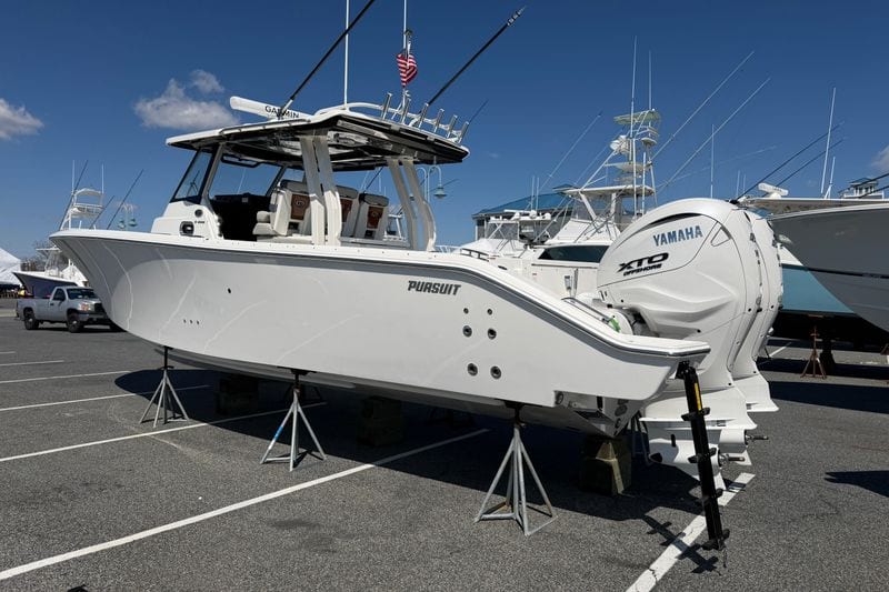 2026 Pursuit S 358 Sport boat with Yamaha engines displayed on stands in a marina.