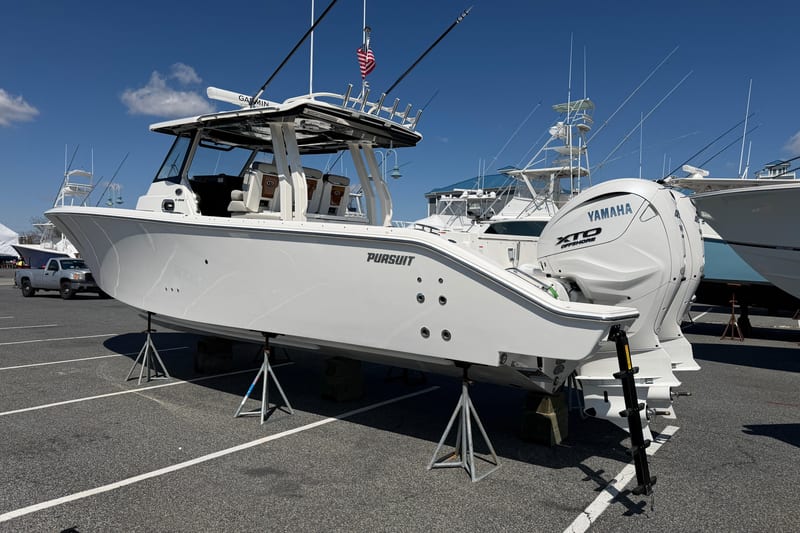 2026 Pursuit S 358 Sport boat with Yamaha engines displayed on stands in a marina.