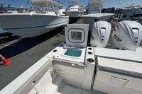 2026 Pursuit S 358 Sport boat with dual engines and open storage compartment.