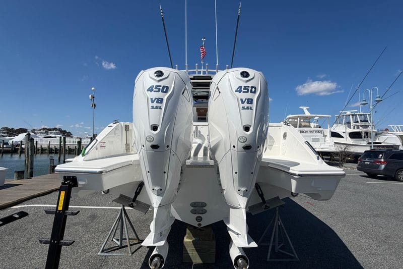 2026 Pursuit S 358 Sport boat with twin 450 V8 engines at a marina.