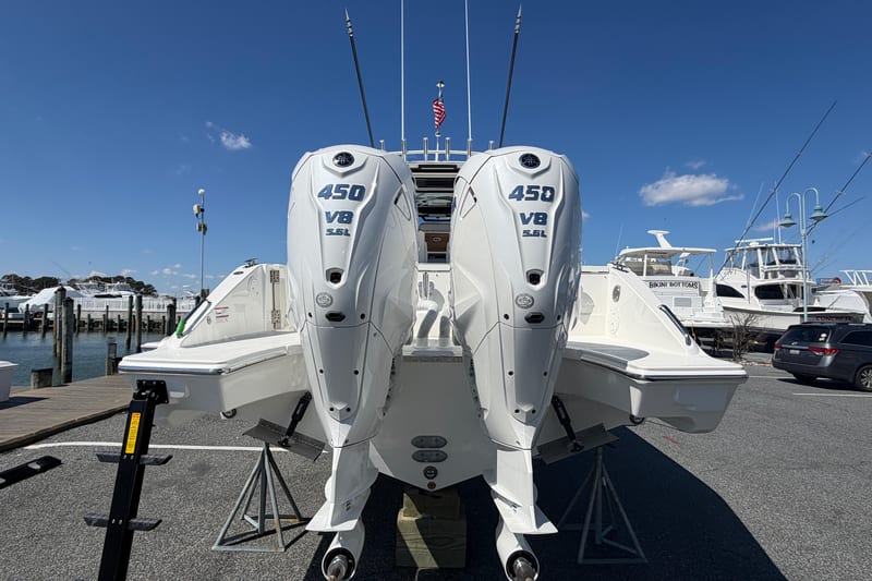 2026 Pursuit S 358 Sport boat with twin 450 V8 engines at a marina.