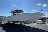 2026 Pursuit S 358 Sport boat displayed on a marina under a clear blue sky.