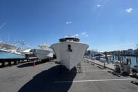 2026 Pursuit S 358 Sport boat docked under clear blue sky.