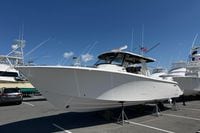 2026 Pursuit S 358 Sport boat displayed in a marina under clear blue skies.