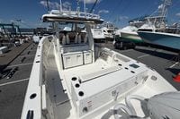2026 Pursuit S 358 Sport boat docked, showcasing spacious deck and seating area.