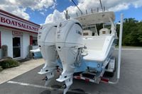 2026 Pursuit DC 286 Dual Console boat with twin Yamaha engines at dealership.