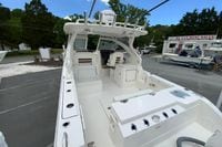 2026 Pursuit DC 286 Dual Console boat at dealership, showcasing spacious deck and seating.