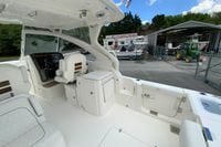 2026 Pursuit DC 286 Dual Console boat interior at a dealership, showcasing seating and helm.