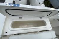 Open storage compartment on 2026 Pursuit DC 286 Dual Console boat.