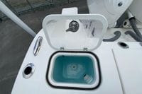 Livewell compartment on 2026 Pursuit DC 286 Dual Console boat, featuring a transparent lid.