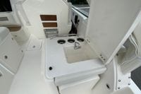 2026 Pursuit DC 286 Dual Console boat interior with sink and seating area.