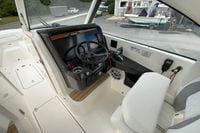 2026 Pursuit DC 286 Dual Console boat cockpit with steering wheel and controls.