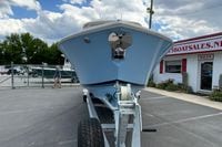 2026 Pursuit DC 286 Dual Console boat on trailer at dealership, under a cloudy sky.