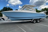 2026 Pursuit DC 286 Dual Console boat on trailer under blue sky.