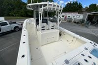 2027 Cobia 320 Center Console boat at dealership, showcasing spacious deck and seating.