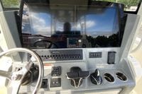 Helm of 2027 Cobia 320 Center Console with dual Garmin displays and modern controls.