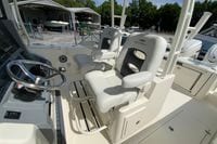 2027 Cobia 320 Center Console boat interior with dual captain's chairs and steering wheel.