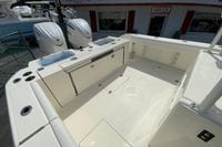 2027 Cobia 320 Center Console boat deck with twin engines and storage compartments.