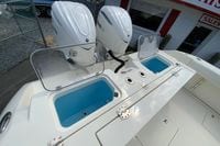 2027 Cobia 320 Center Console with dual Yamaha engines and open storage compartments.