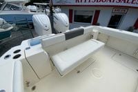 2027 Cobia 320 Center Console boat interior with seating and dual outboard engines.